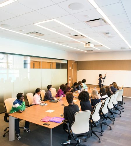 Professional team engaged in a collaborative boardroom meeting with a presentation in progress.